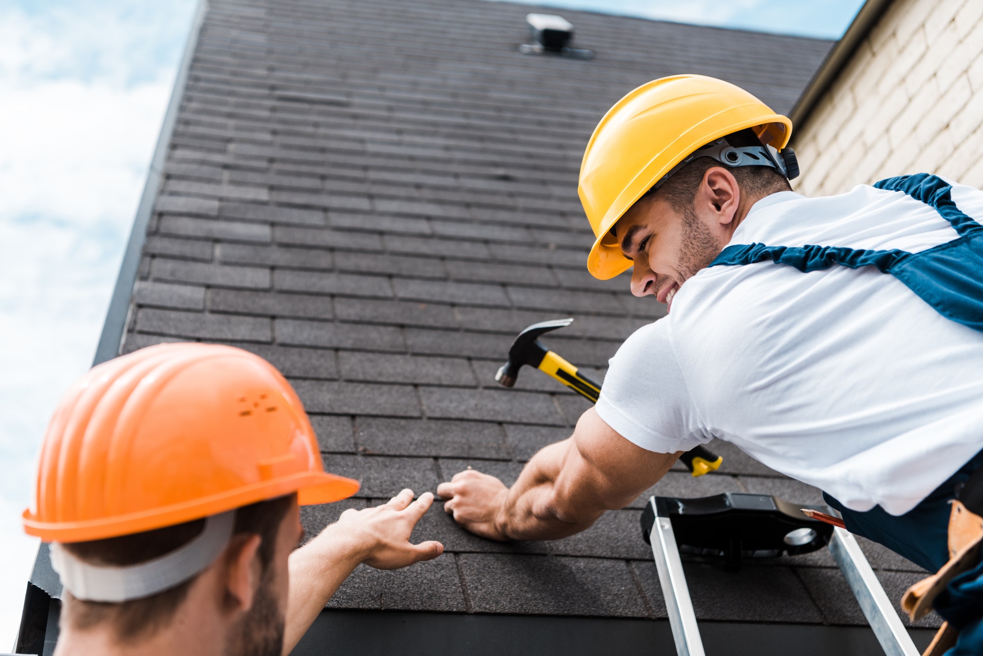 Electricians working on a roof, emphasizing safety and teamwork.